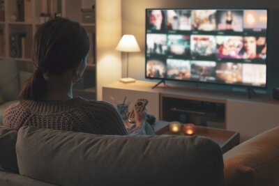 Person watching a TV show on a television in a cozy living room