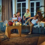 Family watching television together in a cozy living room