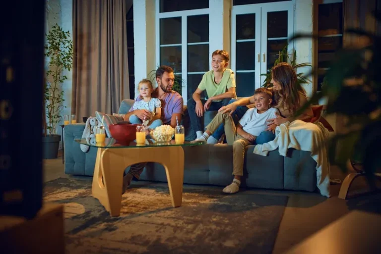 Family watching television together in a cozy living room