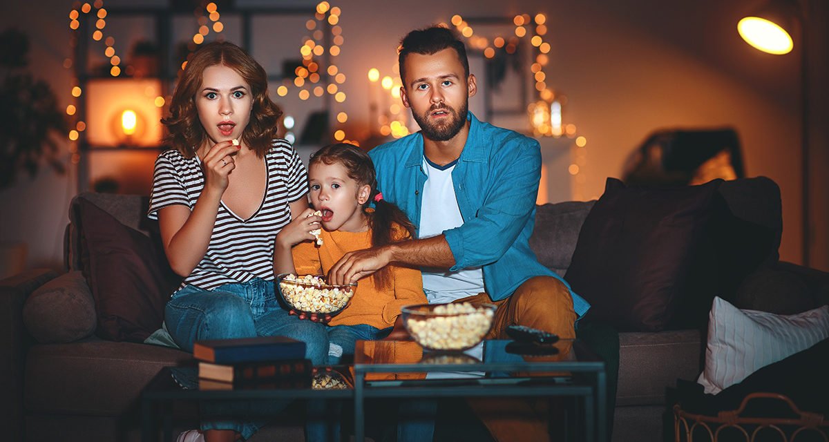 Family watching movies together in a living room